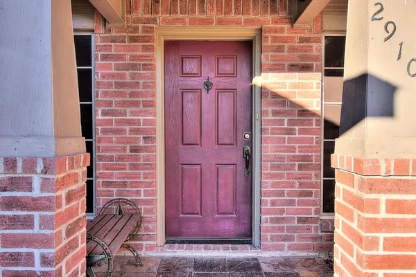 a brick building with red door