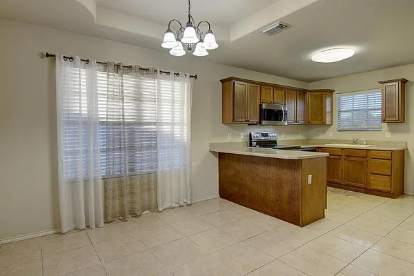 a kitchen with stainless steel appliances granite countertop a stove sink and cabinets