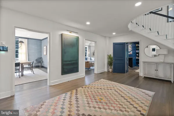 a view of a hallway with wooden floor and furniture