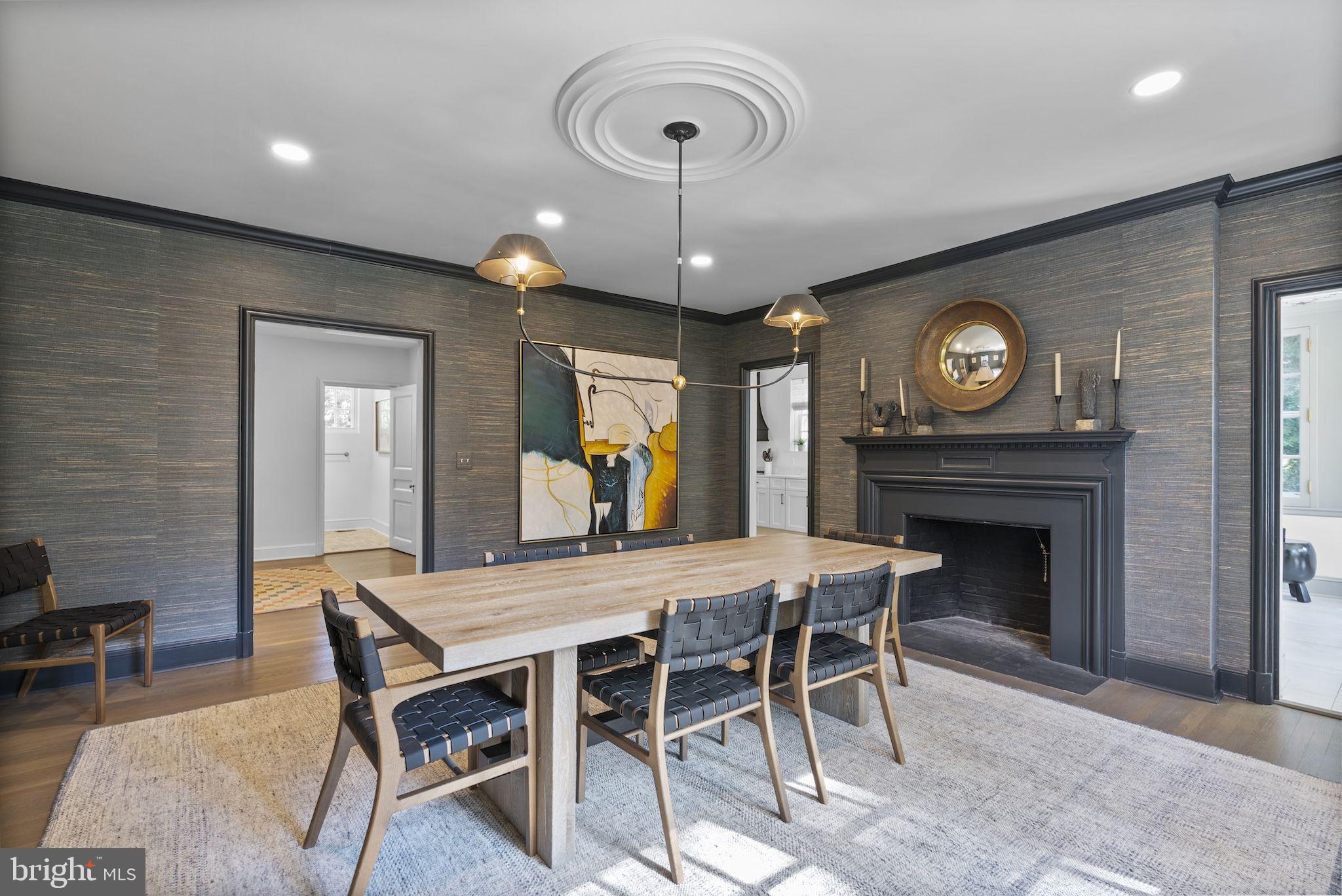 203 East Highfield Road Baltimore, MD 21218 - Photo 16 of 49 a view of a dining room with furniture wooden floor and a fireplace