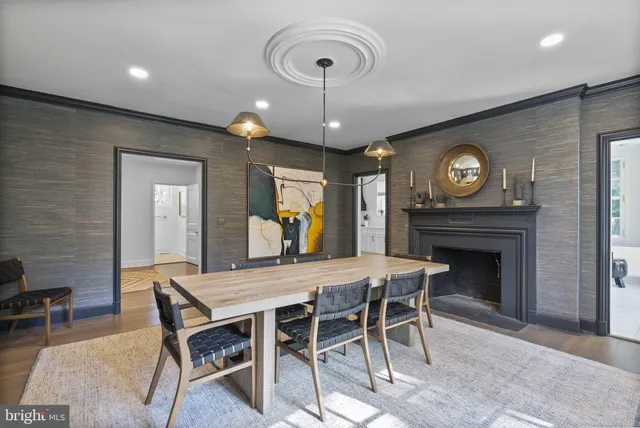 a view of a dining room with furniture wooden floor and a fireplace