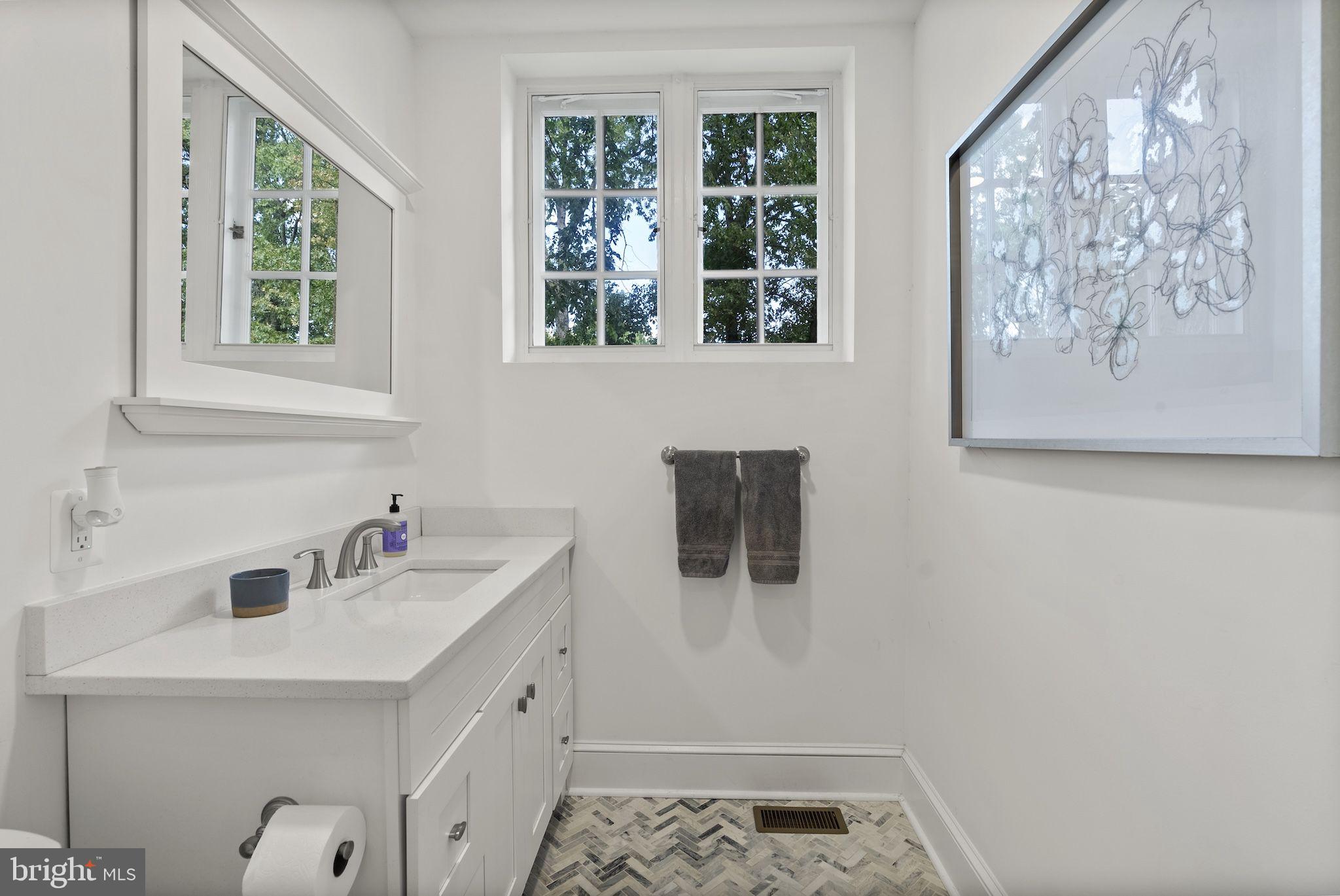 203 East Highfield Road Baltimore, MD 21218 - Photo 23 of 49 a bathroom with a sink and a window