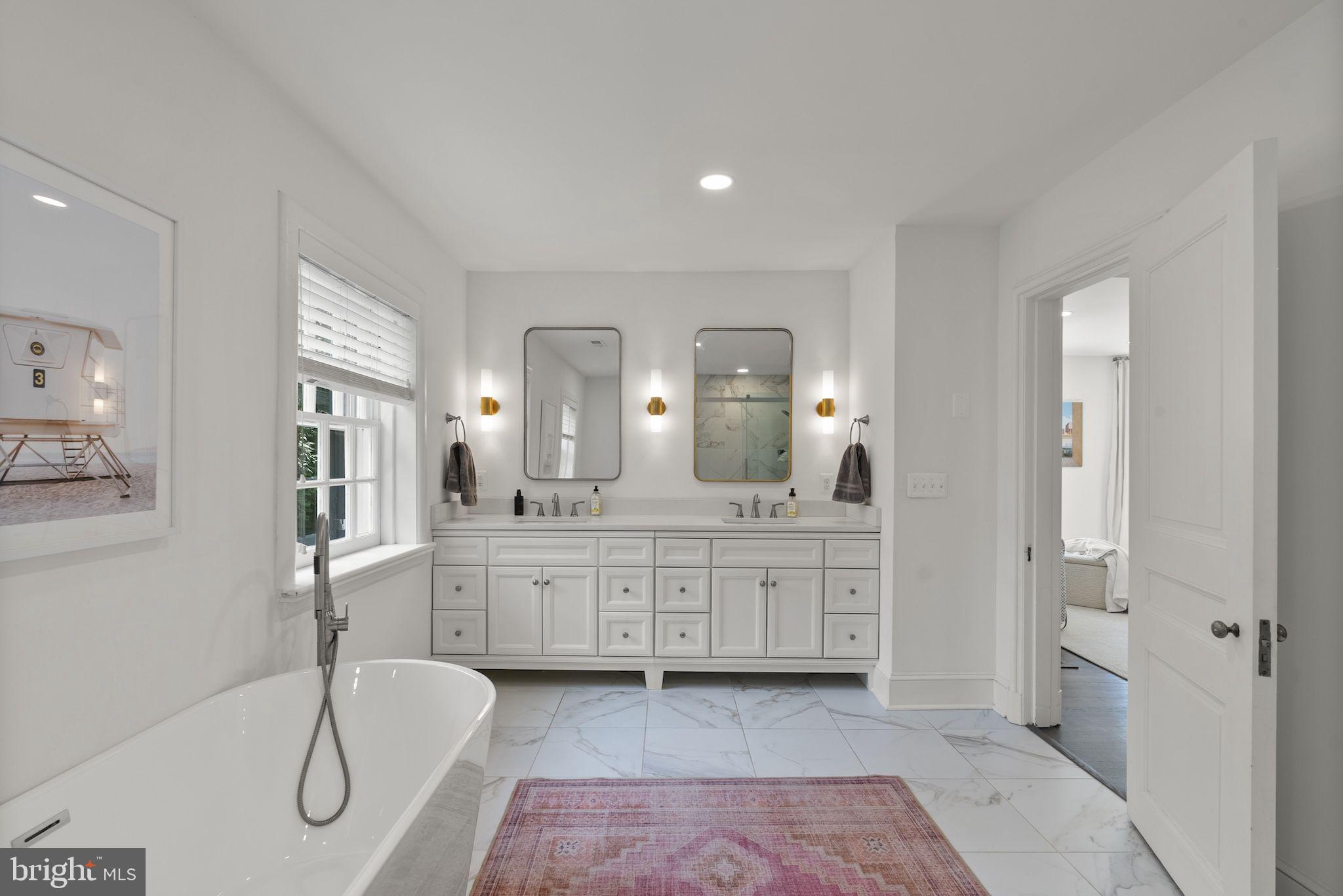 203 East Highfield Road Baltimore, MD 21218 - Photo 27 of 49 a spacious bathroom with a granite countertop sink and a mirror