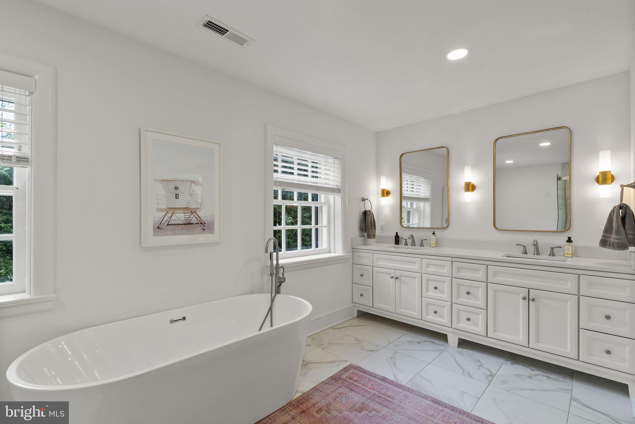 203 East Highfield Road Baltimore, MD 21218 - Photo 28 of 49 a bathroom with a tub a sink shower double vanity