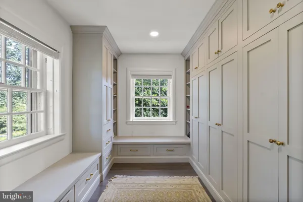 a bathroom with a tub shower and window