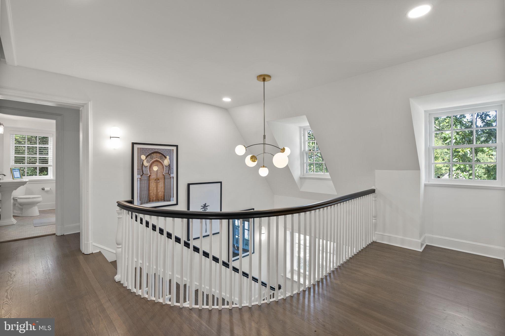 203 East Highfield Road Baltimore, MD 21218 - Photo 31 of 49 a view of a hallway with wooden floor and stairs