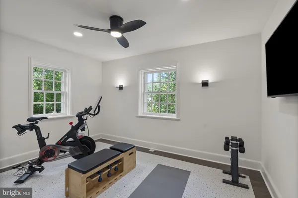a room with gym equipment and windows