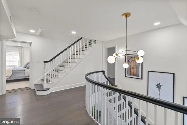 a view of an entryway wooden floor and a chandelier