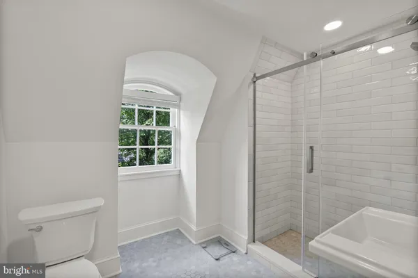 a bathroom with a toilet and a shower