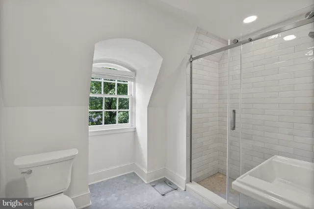 a bathroom with a toilet and a shower