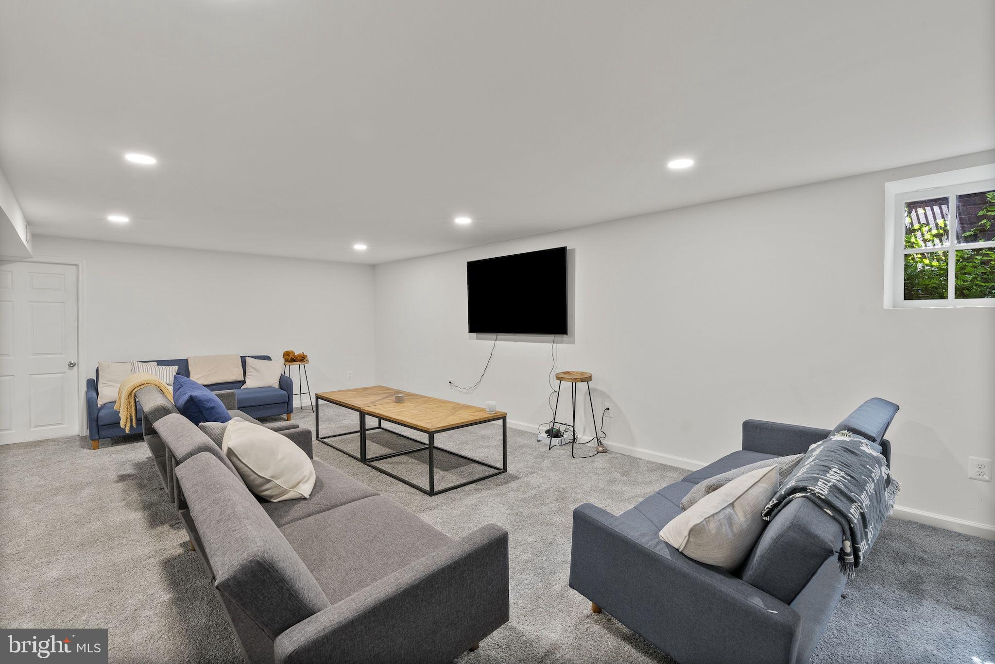 203 East Highfield Road Baltimore, MD 21218 - Photo 42 of 49 a living room with furniture and a flat screen tv