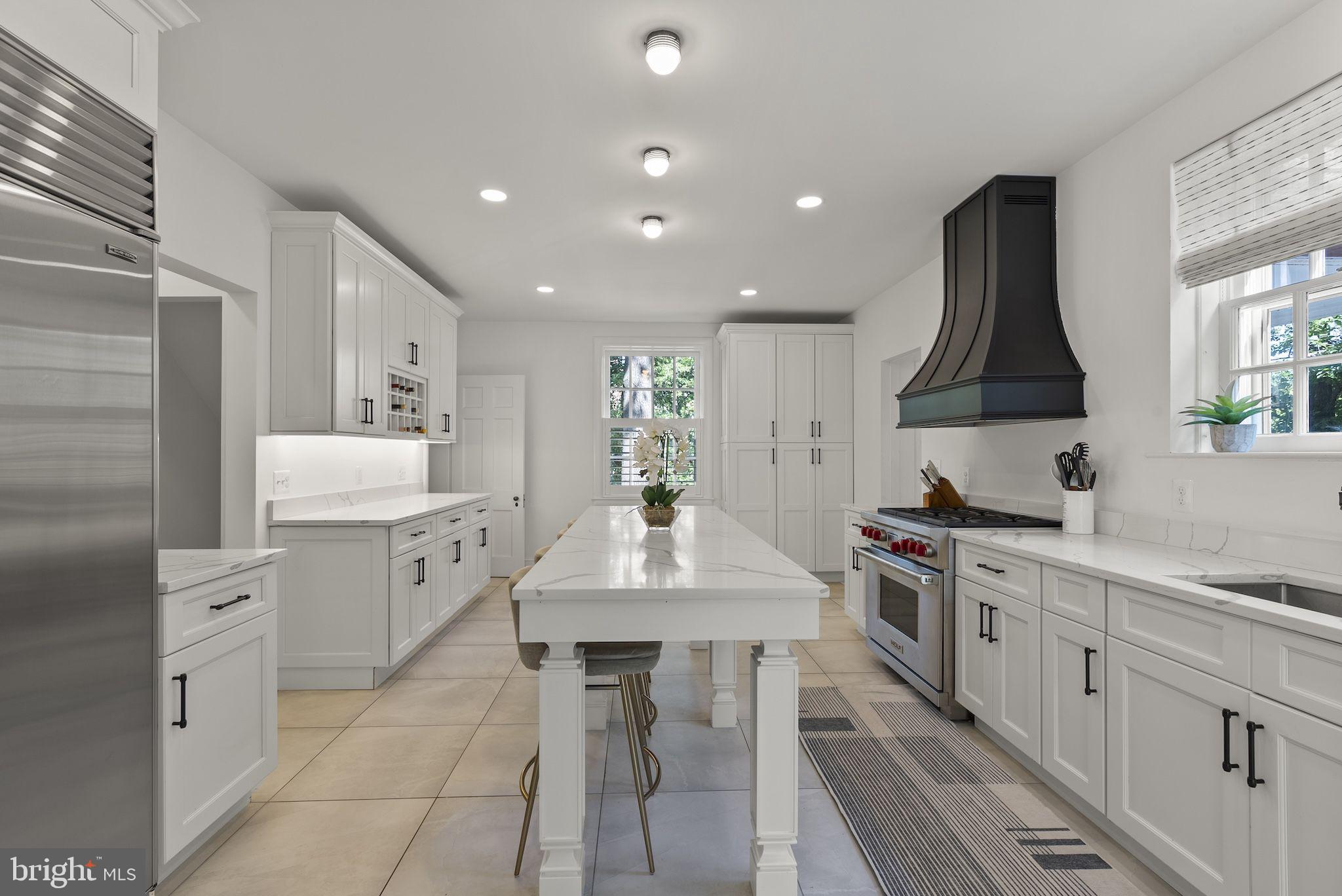 203 East Highfield Road Baltimore, MD 21218 - Photo 5 of 49 a kitchen with a sink stove and white cabinets