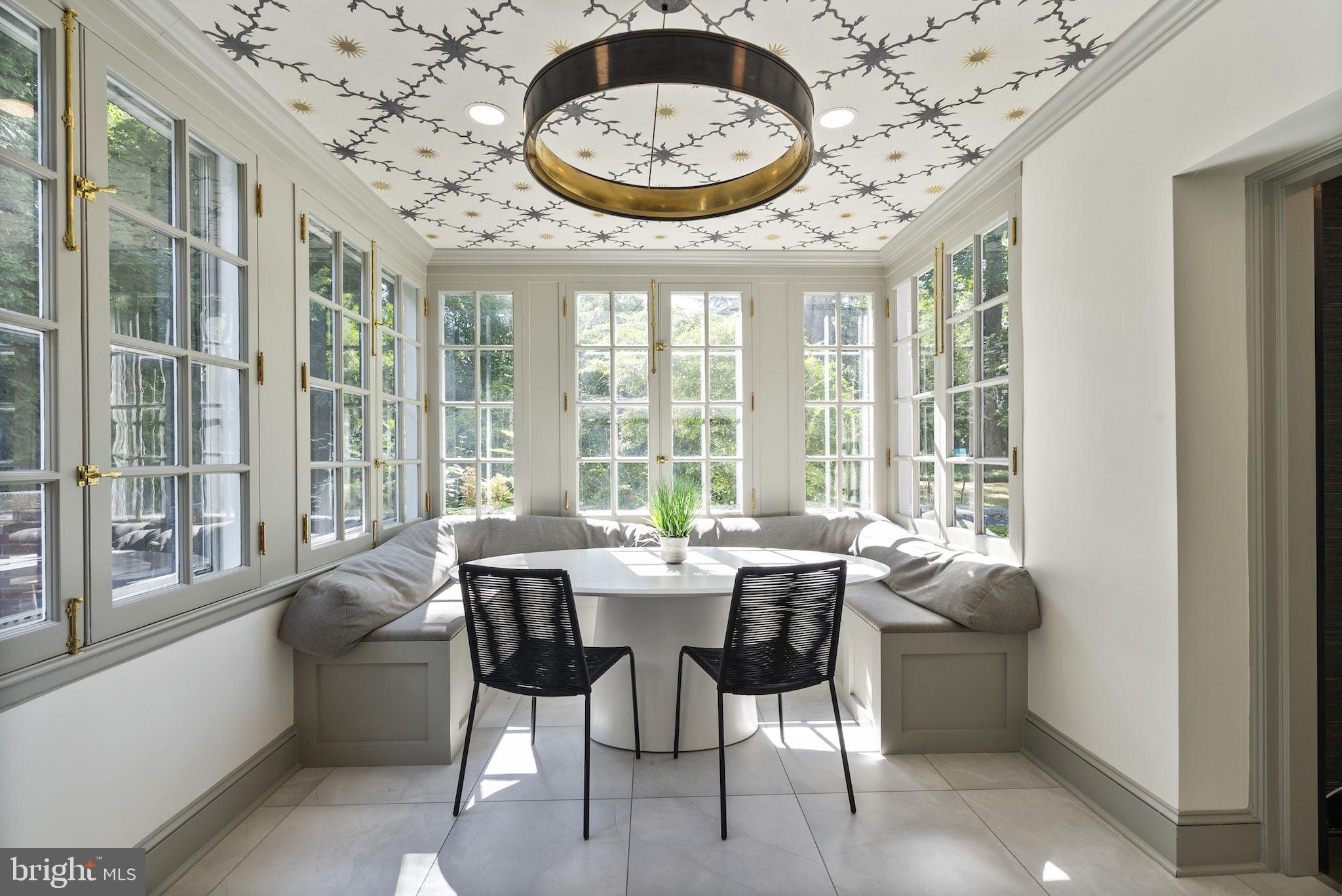 203 East Highfield Road Baltimore, MD 21218 - Photo 7 of 49 a view of a dining room with furniture large windows and a chandelier