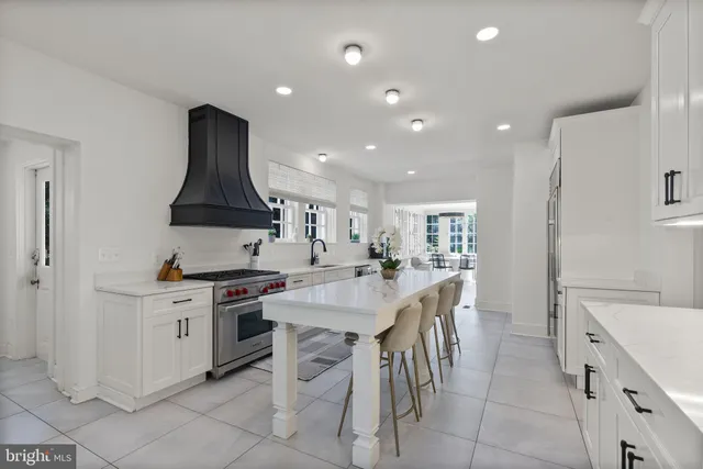 a kitchen with stainless steel appliances a sink stove and cabinets