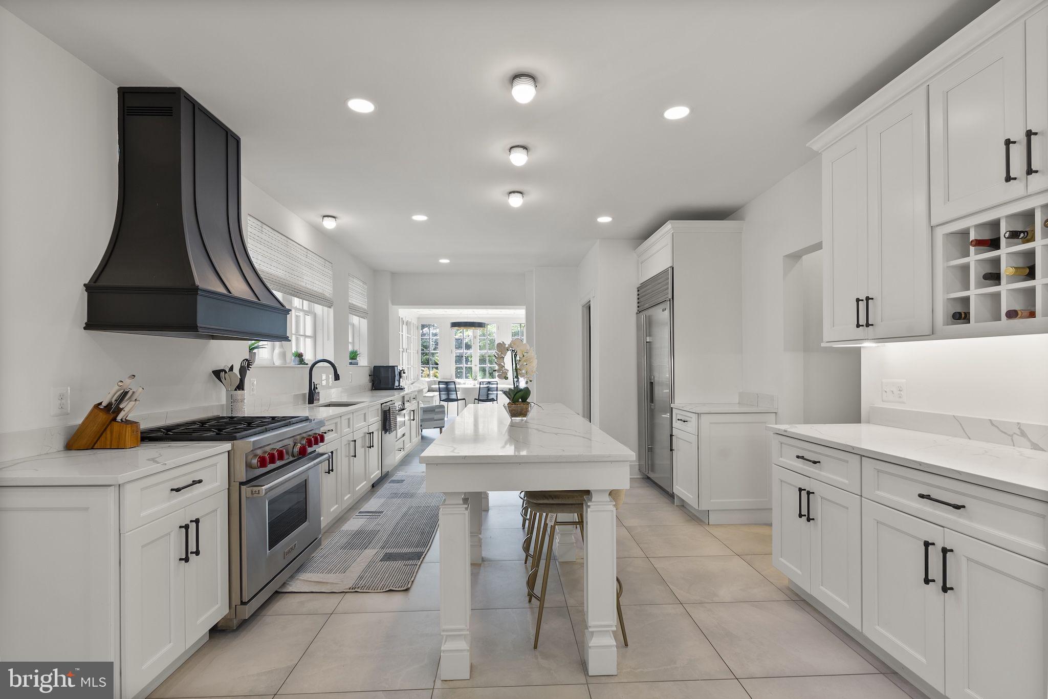 203 East Highfield Road Baltimore, MD 21218 - Photo 10 of 49 a kitchen with white cabinets and stainless steel appliances