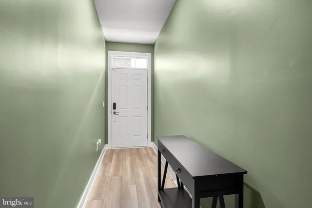a view of a room with wooden floor and bathroom