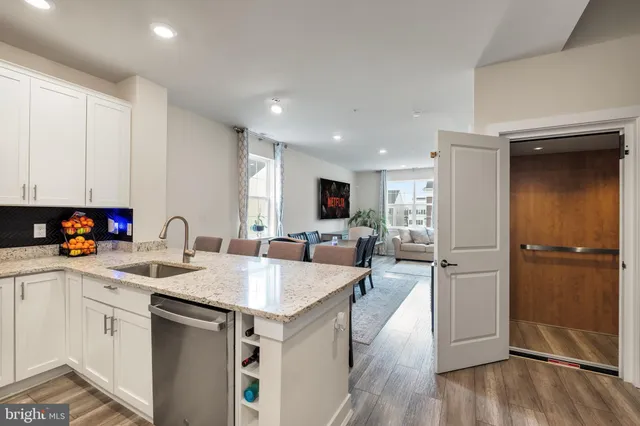 a kitchen with a sink appliances and cabinets