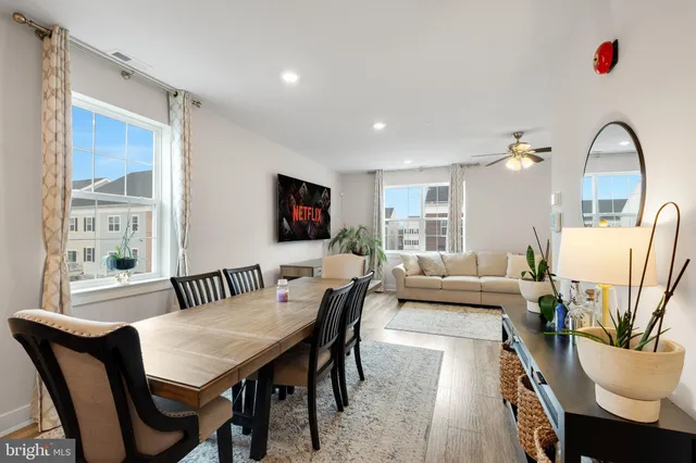 a living room with furniture a rug and a flat screen tv