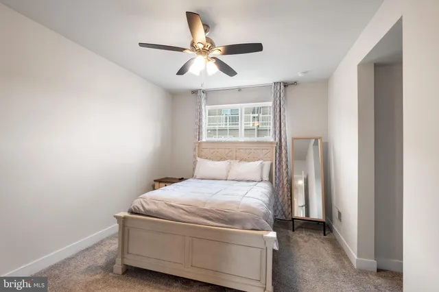 a bedroom with a bed and a ceiling fan