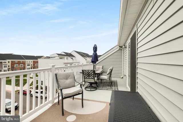 a balcony with table and chairs