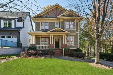 a front view of a house with a yard and porch