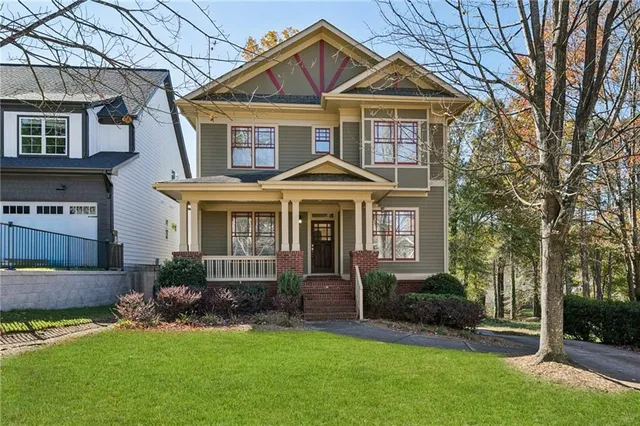 a front view of a house with a yard and porch