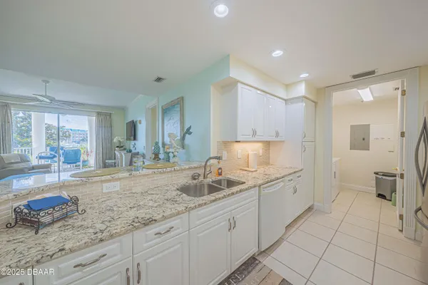 a spacious bathroom with a granite countertop sink a mirror and a shower