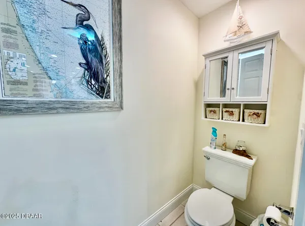 a white toilet sitting next to a bathroom sink