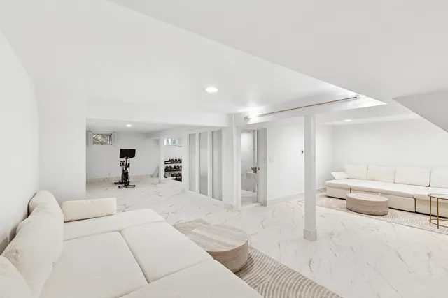 a living room with furniture and a large mirror