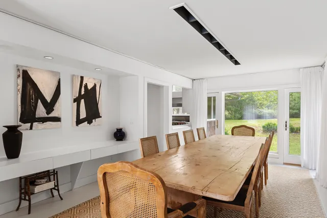 a view of a dining room with furniture and a window