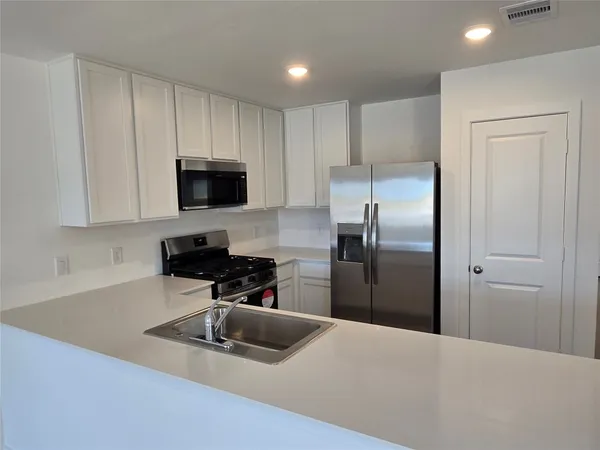 a view of a kitchen with a sink and dishwasher