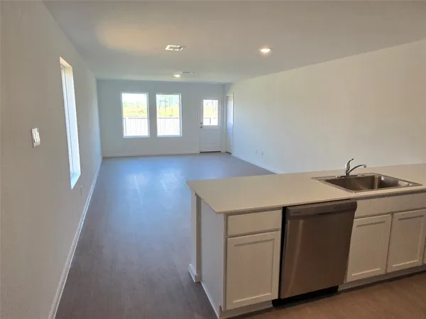 a view of a kitchen with a sink and a window