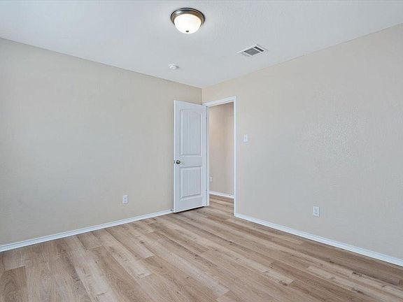 904 Lonesome Lilly Way Pflugerville, TX 78660 - Photo 21 of 34 This room features light-colored walls, light wood-style flooring, and a white ceiling with a flush-mount light fixture