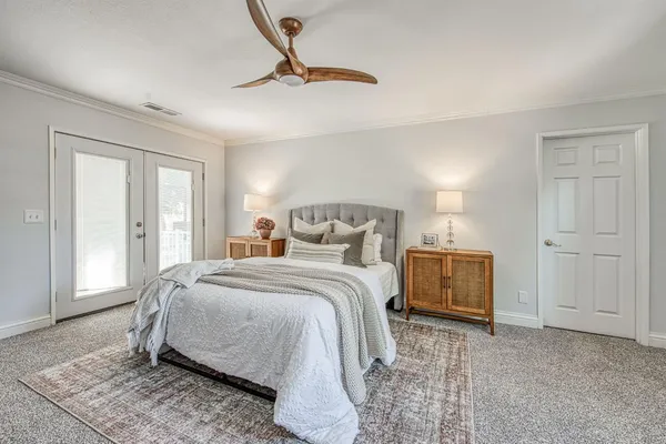 a bedroom with a bed a window and closet