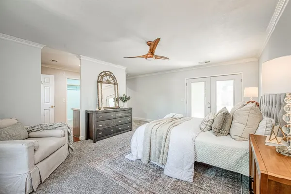 a bedroom with a bed couches and a dresser