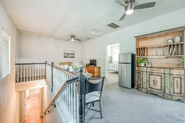 a view of a hallway with seating area