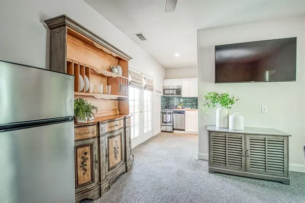 a view of kitchen with refrigerator and microwave