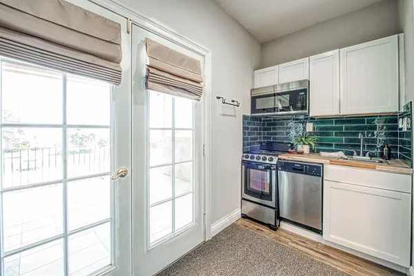 a kitchen with stainless steel appliances a sink and a window