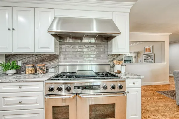 a stove top oven sitting inside of a kitchen