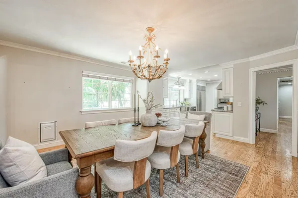 a view of a dining room with furniture wooden floor and a chandelier