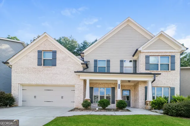 a front view of a house with a yard and garage