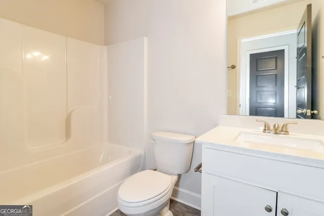 a bathroom with a toilet a sink and a bathtub