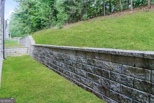 a view of a backyard with a wooden fence