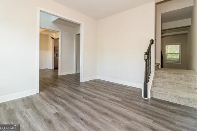 a view of a hallway with wooden floor