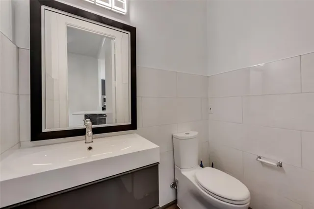a bathroom with a sink a toilet and mirror