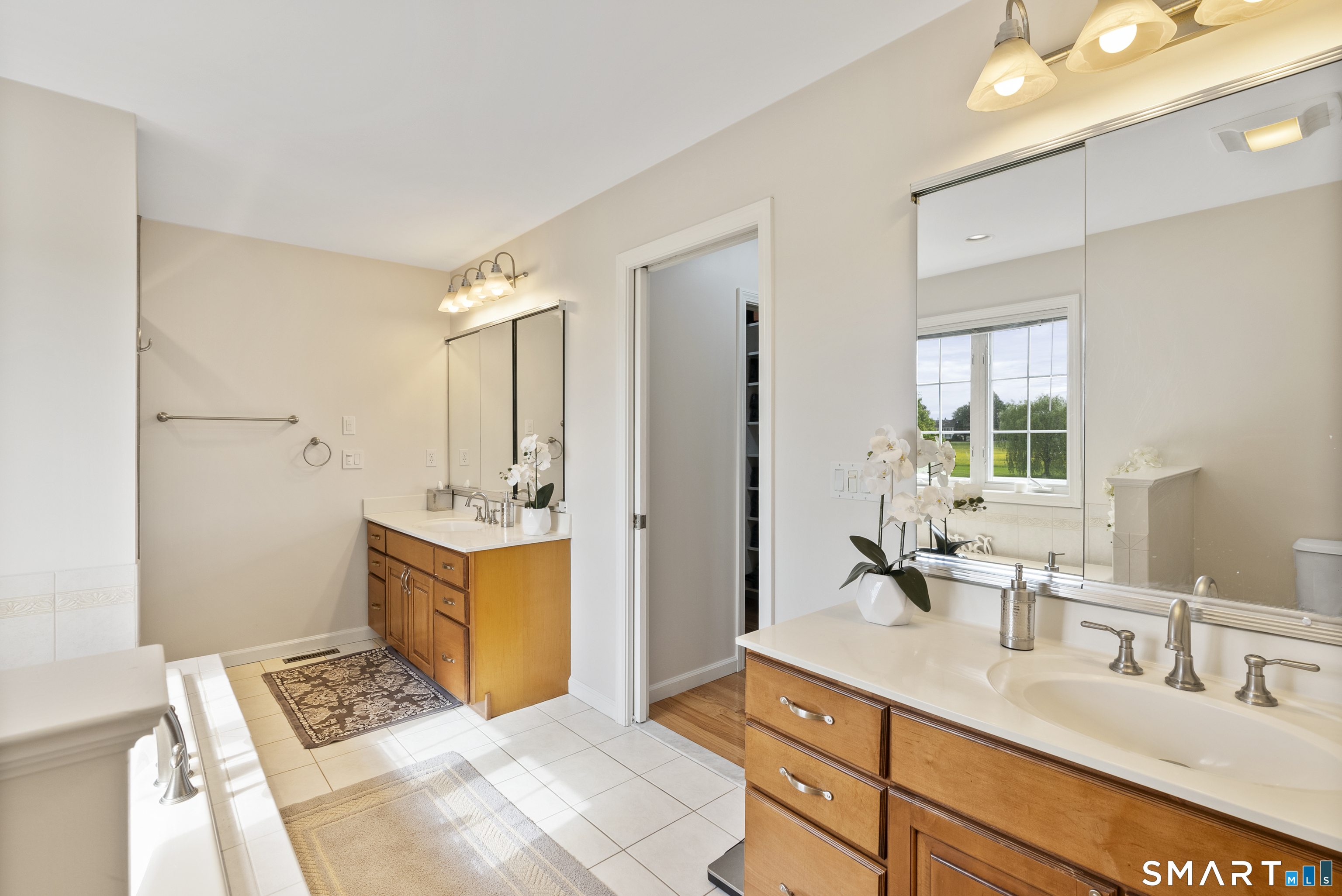 44 Farmstead Lane Suffield, CT 06078 - Photo 13 of 39 a spacious bathroom with a double vanity sink a mirror and a shower