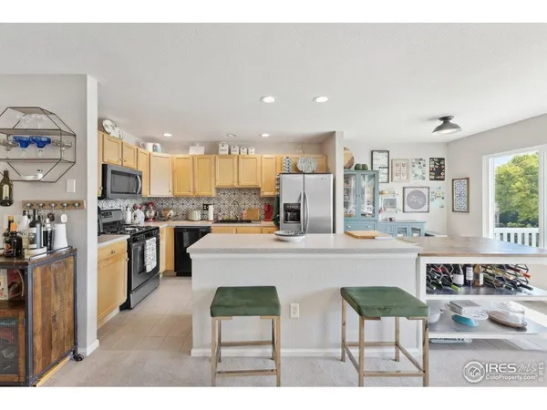 a large kitchen with a table and chairs