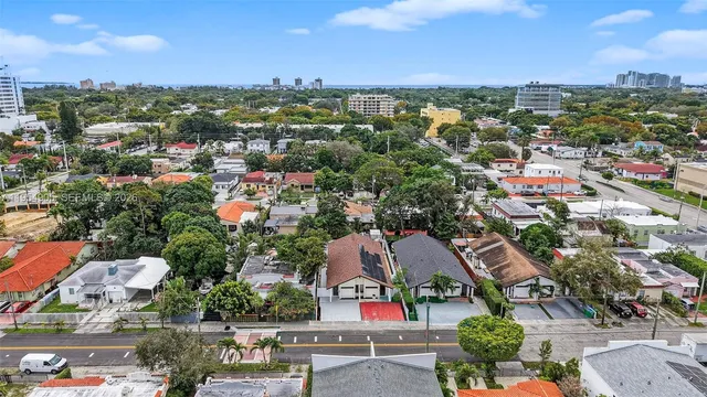 an aerial view of residential houses with outdoor space and street view
