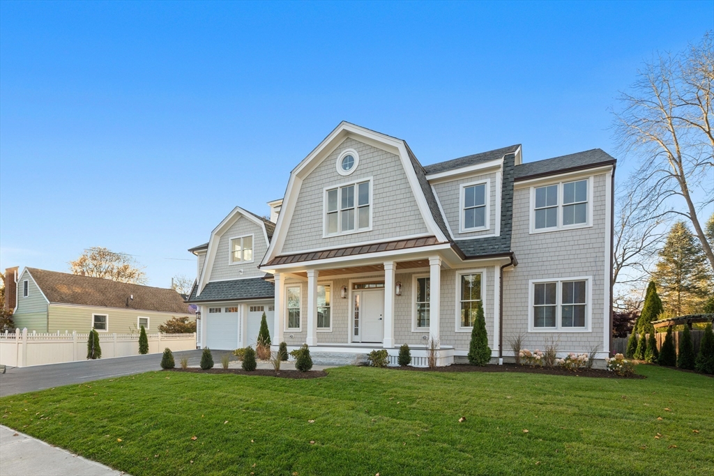 a front view of a house with a garden