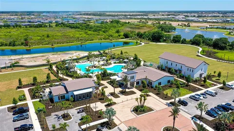 an aerial view of a building with garden space and ocean view